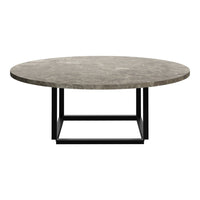 Round coffee table with a textured gray marble top and a sleek black metal base. Stylish and modern design.