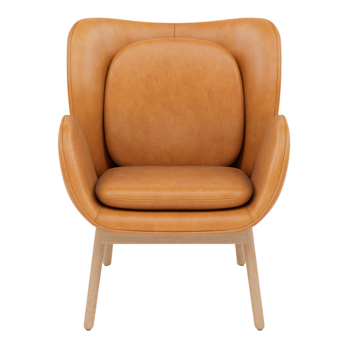Tan leather armchair with smooth curves and a minimalist design, featuring light wooden legs for a modern touch.