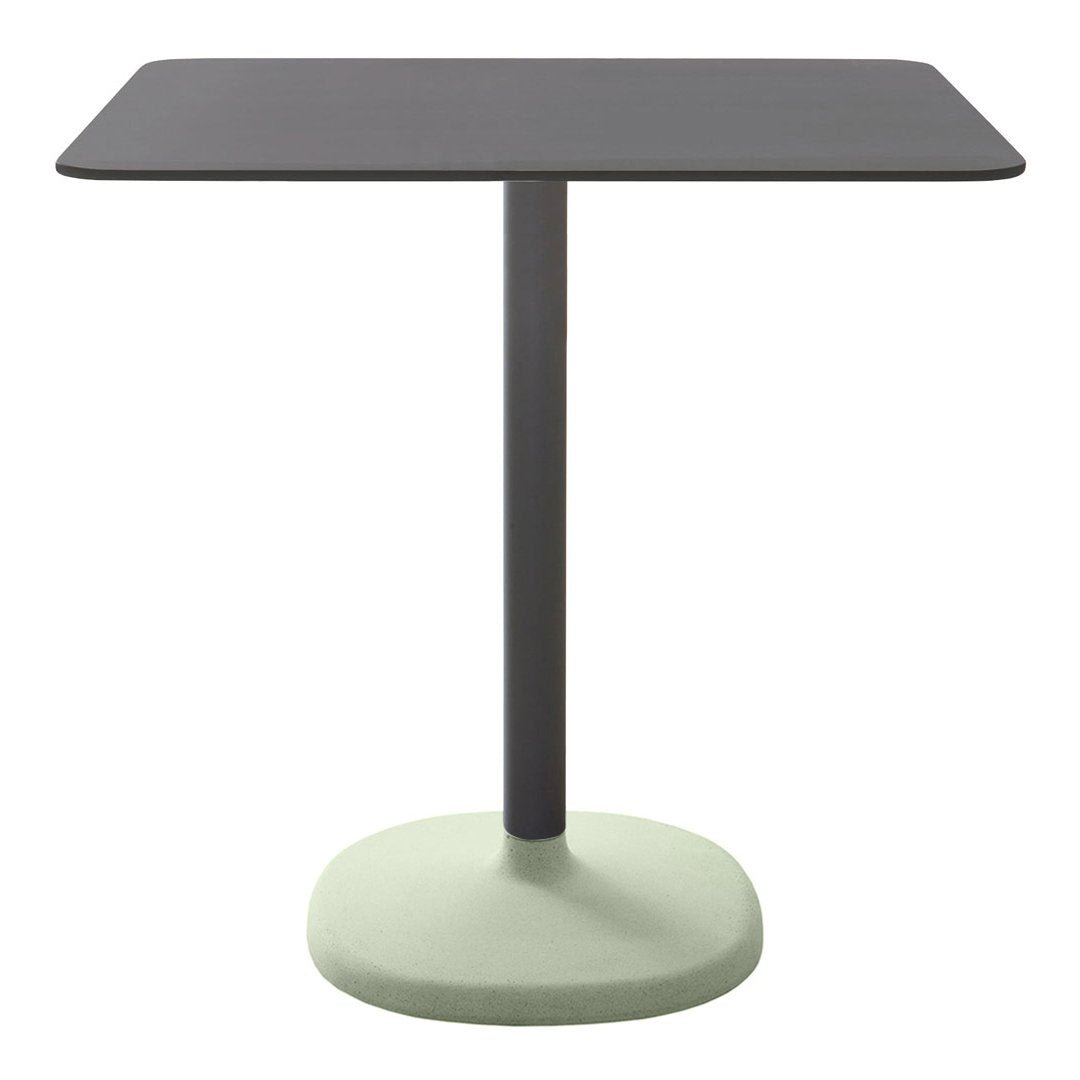 Rectangular table with a sleek black top and a soft green base, featuring a minimalist design and modern color palette.