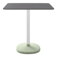 Colorful modern table featuring a black rectangular top, white pole, and mint green base. Simple and stylish design.