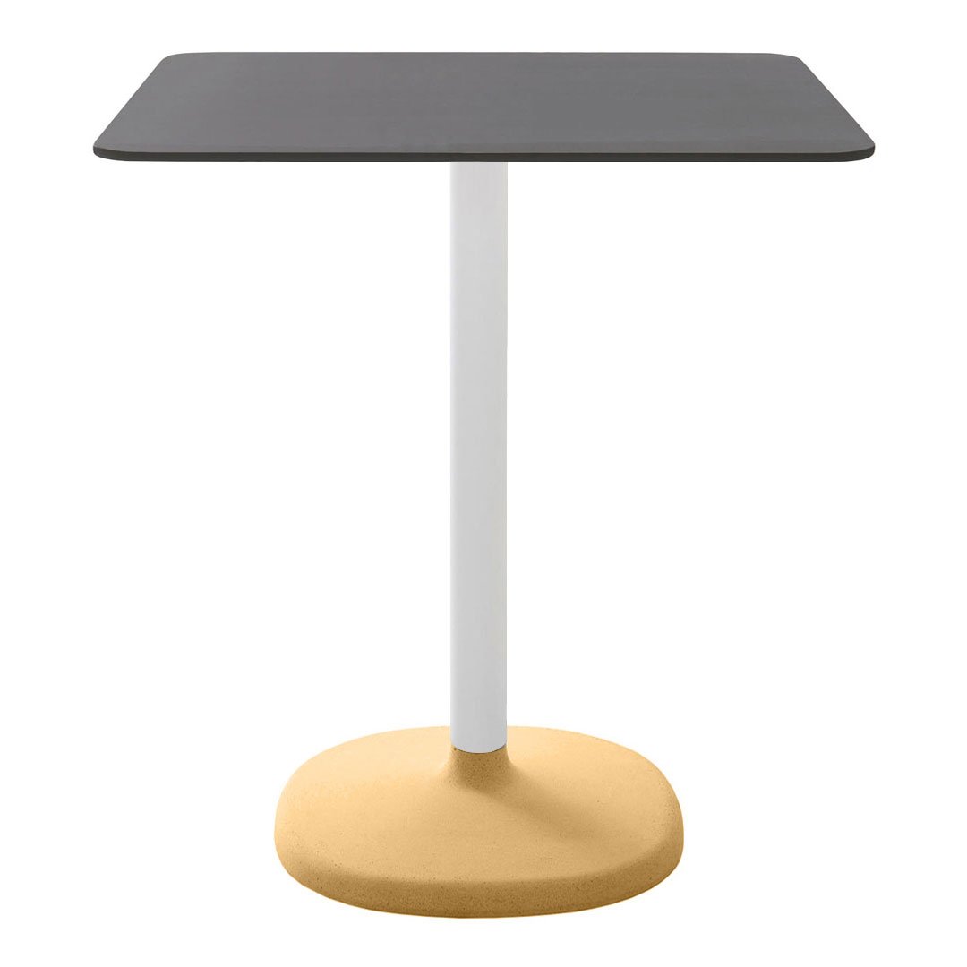 Square table with a sleek black top, white pedestal, and a round yellow base, featuring a modern, minimalist design.