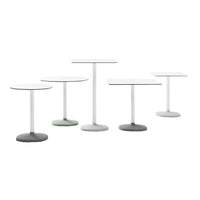 Set of five modern tables featuring white, gray, and muted green colors with sleek, minimalist designs.