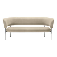 Beige curved sofa with smooth upholstery and minimalist chrome legs, perfect for modern interiors.