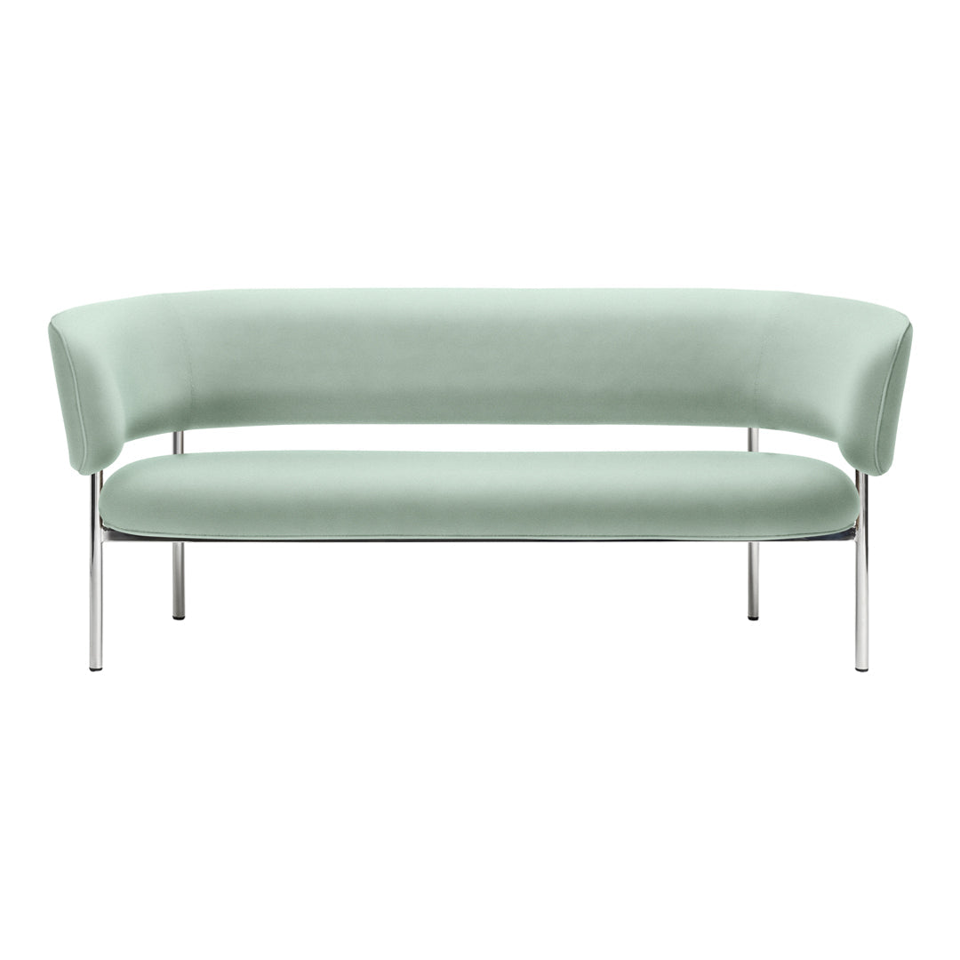 Mint green curved sofa with sleek chrome legs, featuring a smooth, minimalist design. Ideal for modern decor.