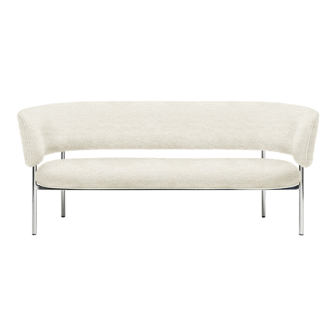 Cream curved sofa with plush upholstery and sleek chrome legs, featuring a minimalist design and soft textures.