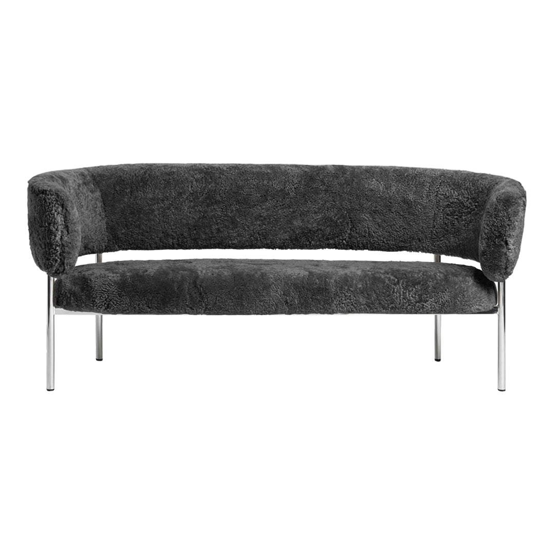 Cozy dark gray upholstered sofa with a smooth, curved design and sleek chrome legs. Ideal for modern interiors.