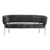 Cozy dark gray upholstered sofa with a smooth, curved design and sleek chrome legs. Ideal for modern interiors.