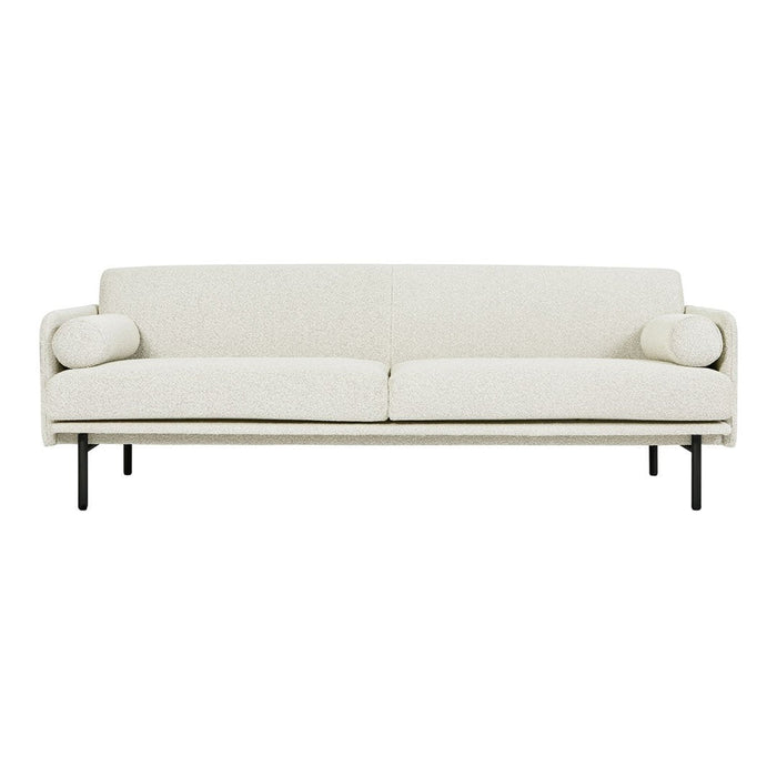 Cream-colored, minimalist sofa with subtle texture and decorative round cushions on each side.