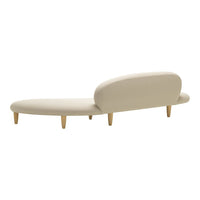 Minimalist beige chaise lounge with smooth contours and natural wood legs, perfect for modern decor.