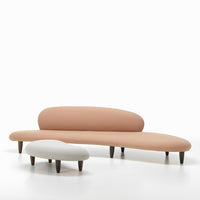 Curved sofa set in soft peach and white hues with wooden legs, featuring a contemporary organic design.