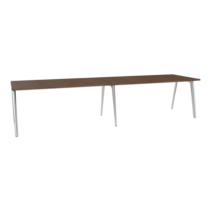 Long wooden table with a rich brown finish and sleek silver legs, featuring a minimalist design and smooth surface.
