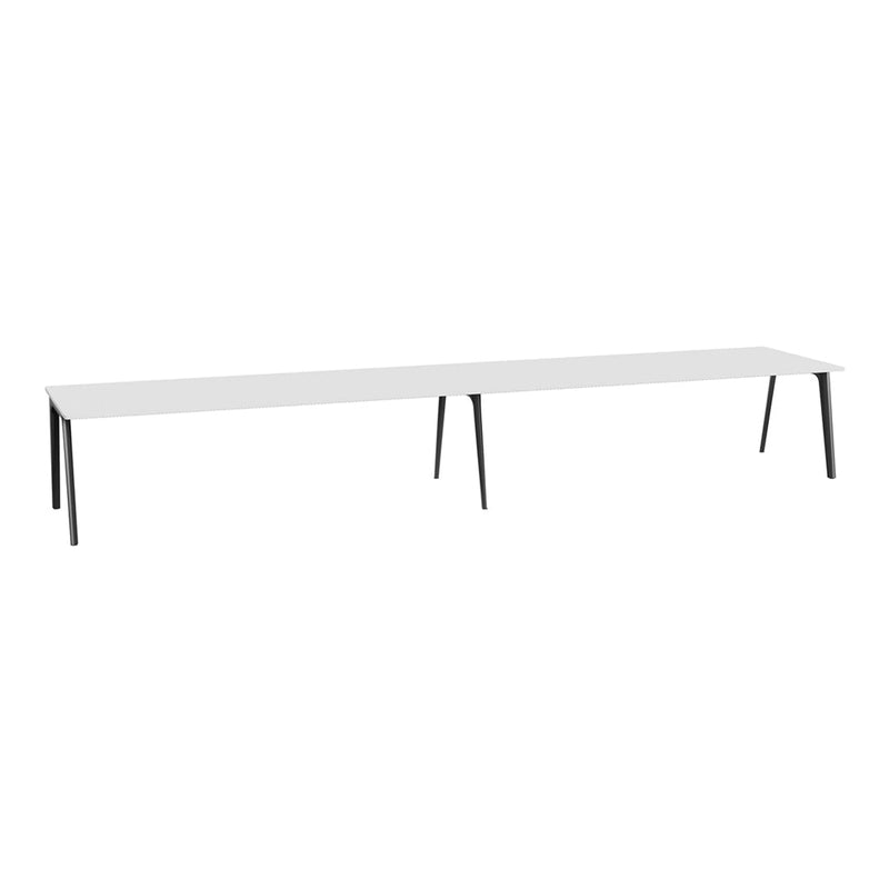 Modern long white table with sleek black legs, featuring a minimalist design and refined color palette.