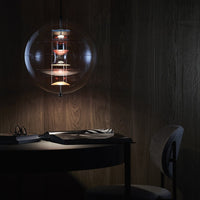Sleek glass pendant light with warm metallic accents, illuminating a dark wood backdrop. Elegant minimalism and modern design.
