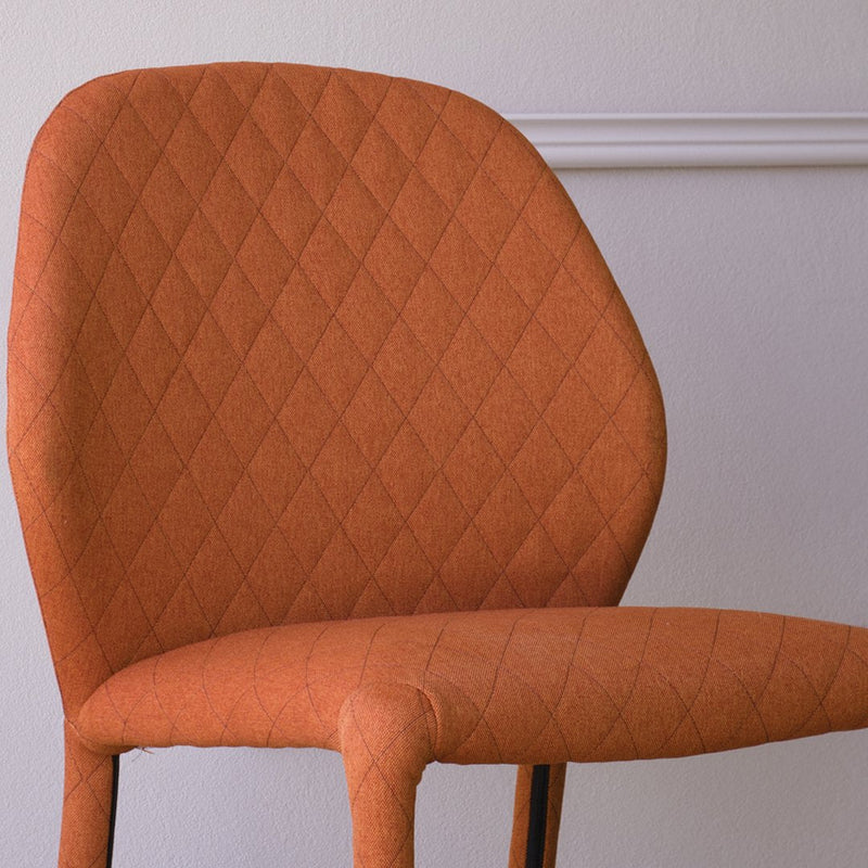 Orange textured chair with a diamond pattern, perfect for modern decor.