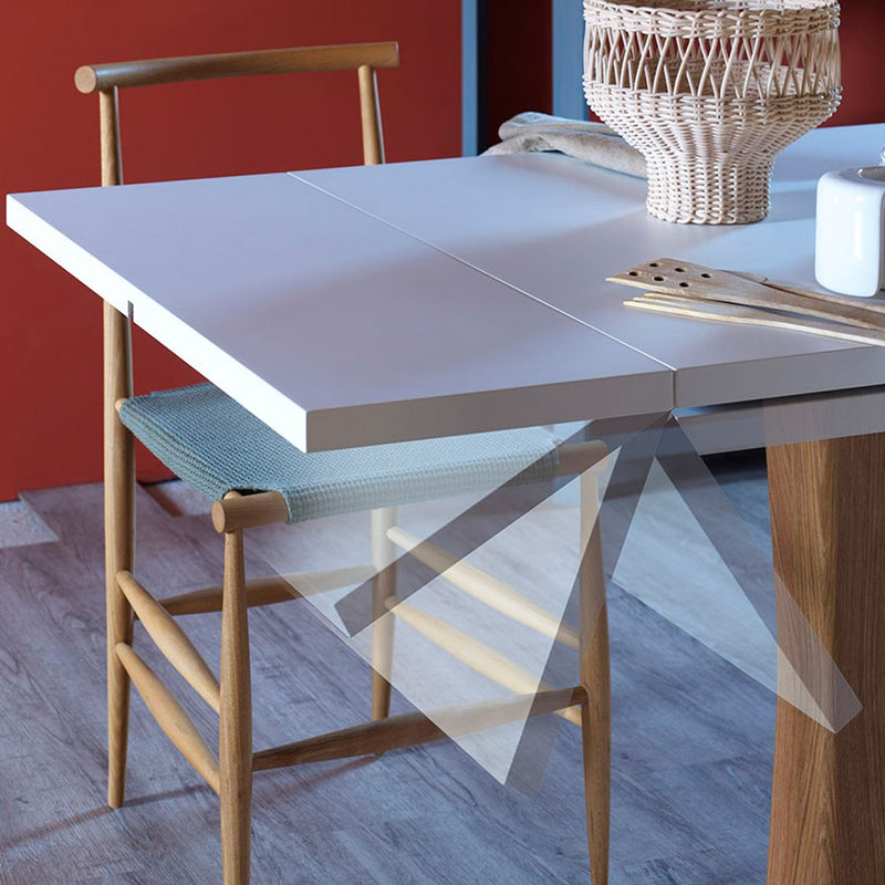 Minimalist white table with light wooden accents and a pastel blue chair, set against a warm red backdrop.