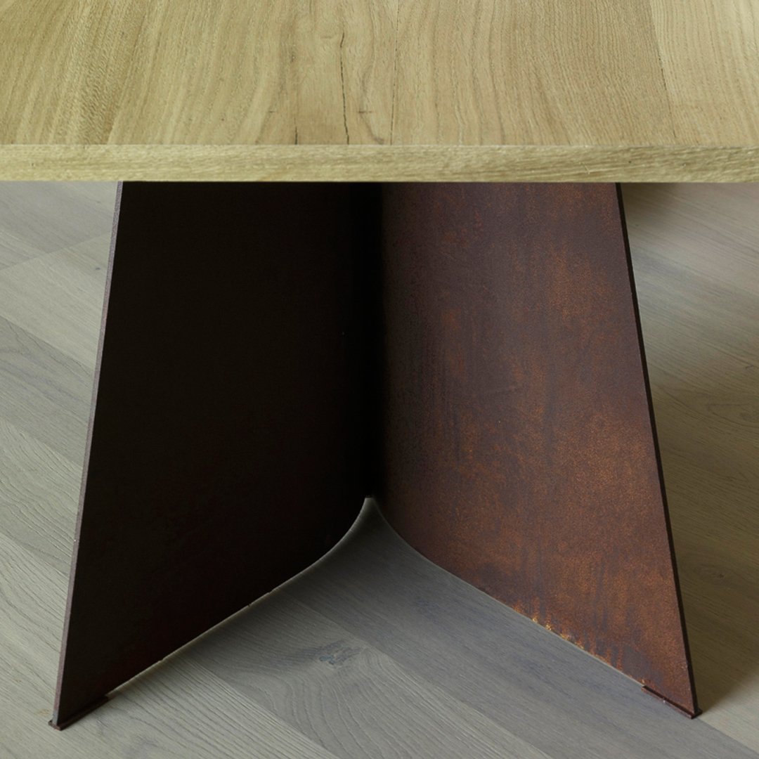 Rustic wooden tabletop with a sleek, brown metal base featuring a textured finish. Modern design elements combined.