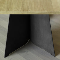 Natural wood tabletop with a sleek black angled base, showcasing minimalist design and modern color contrast.