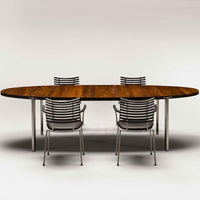 Wooden oval dining table with a rich brown finish and silver metal legs, complemented by sleek striped chairs.