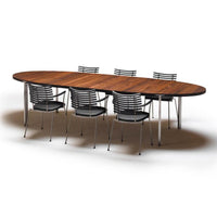 Oval wooden table with a rich brown finish, paired with sleek silver metal chairs featuring black stripes.
