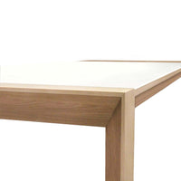 Modern wooden table with a white surface and natural wood finish, showcasing clean lines and a minimalistic design.