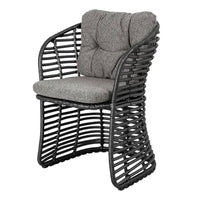 Stylish black wicker chair with a textured gray cushion, featuring a modern, open weave design.