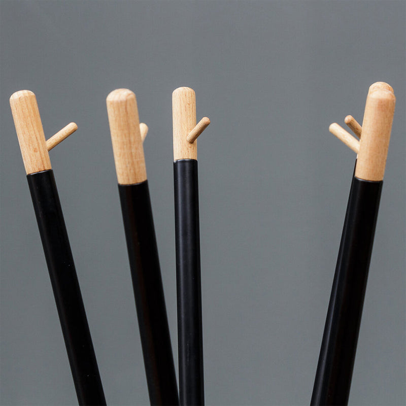 Black and natural wood coat hooks with minimalist design against a gray background. Perfect for modern decor.