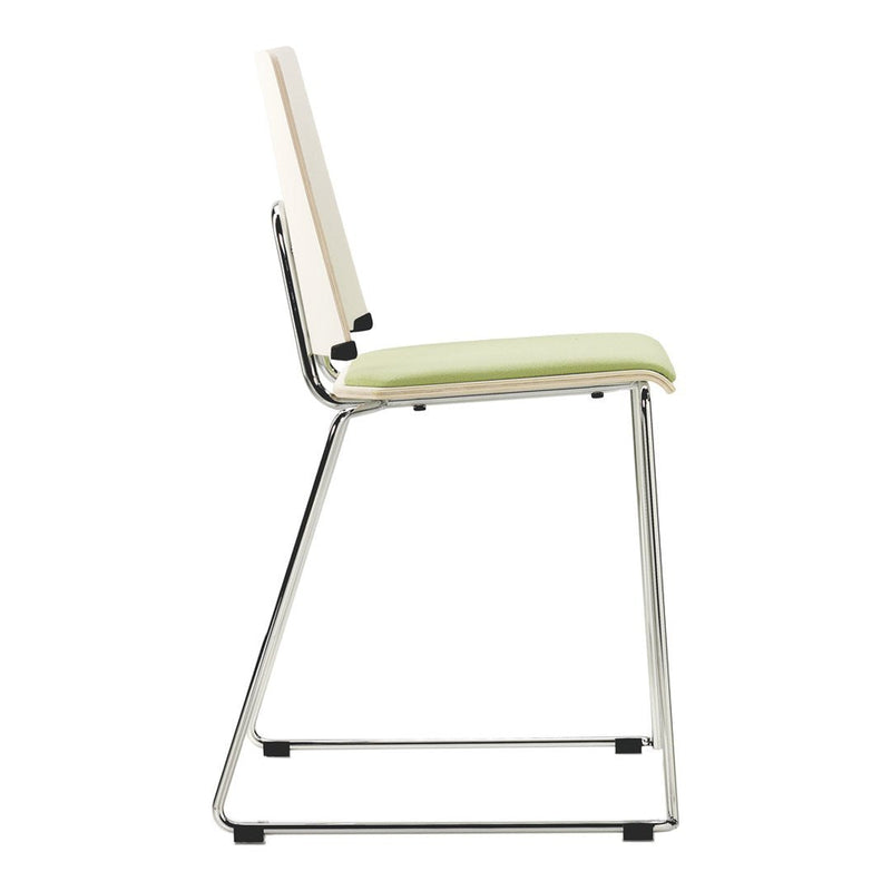 Side view of a sleek chair with a light green cushion and a clean white backrest, featuring a chrome frame.
