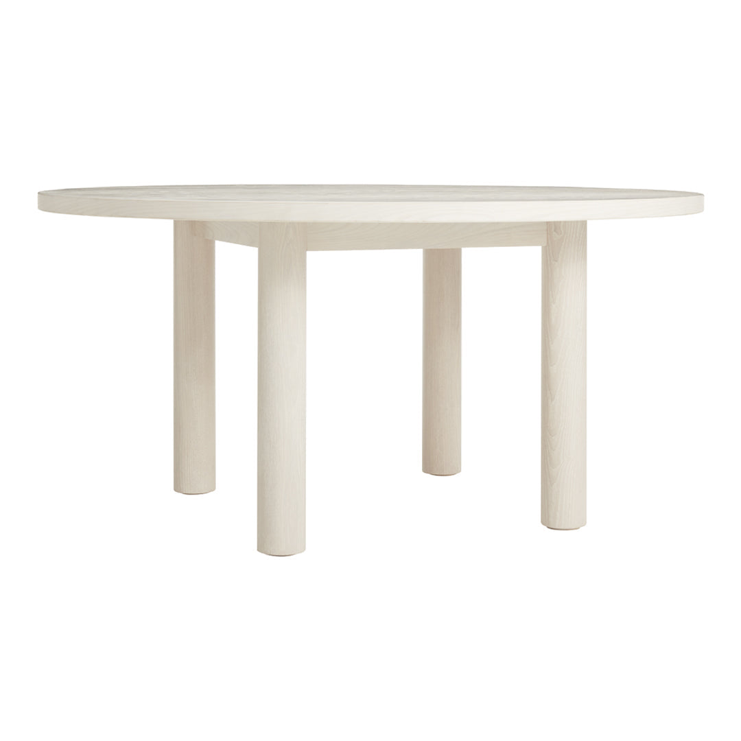 Round dining table in soft beige with a smooth surface and cylindrical legs, featuring a minimalistic design.