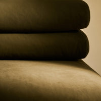 Dark green layered fabric with smooth, textured patterns, showcasing a rich, earthy tone. Perfect for modern decor.