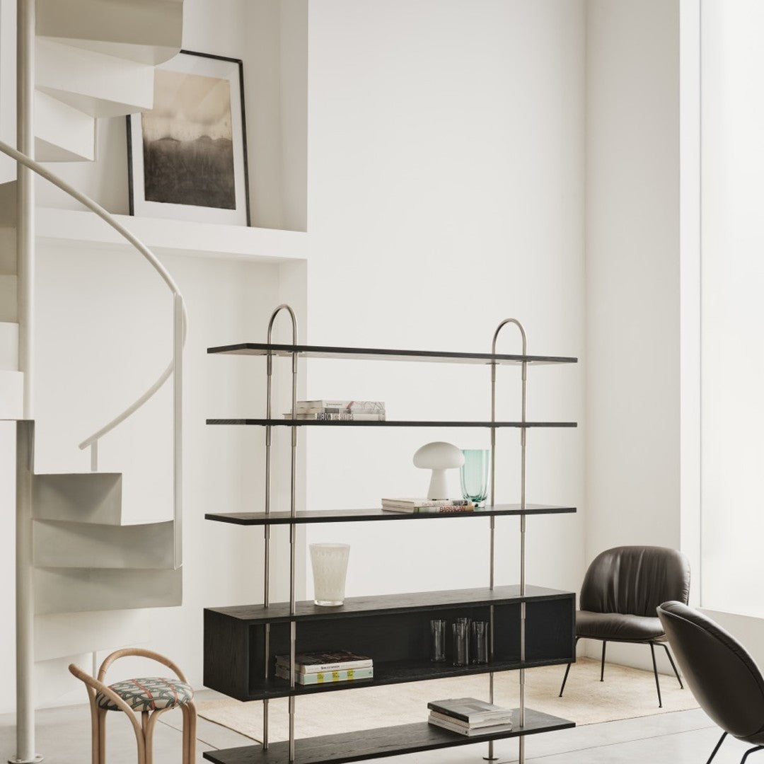 Elegant black metal shelving unit with clear and frosted glass accents in a minimalist, neutral-toned setting.