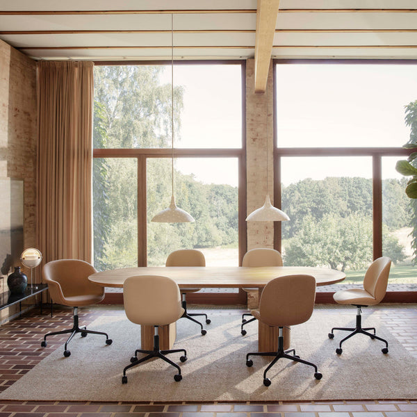Elegant beige office chairs on a textured rug, surrounded by natural light and greenery, showcasing warm earth tones and soft patterns.