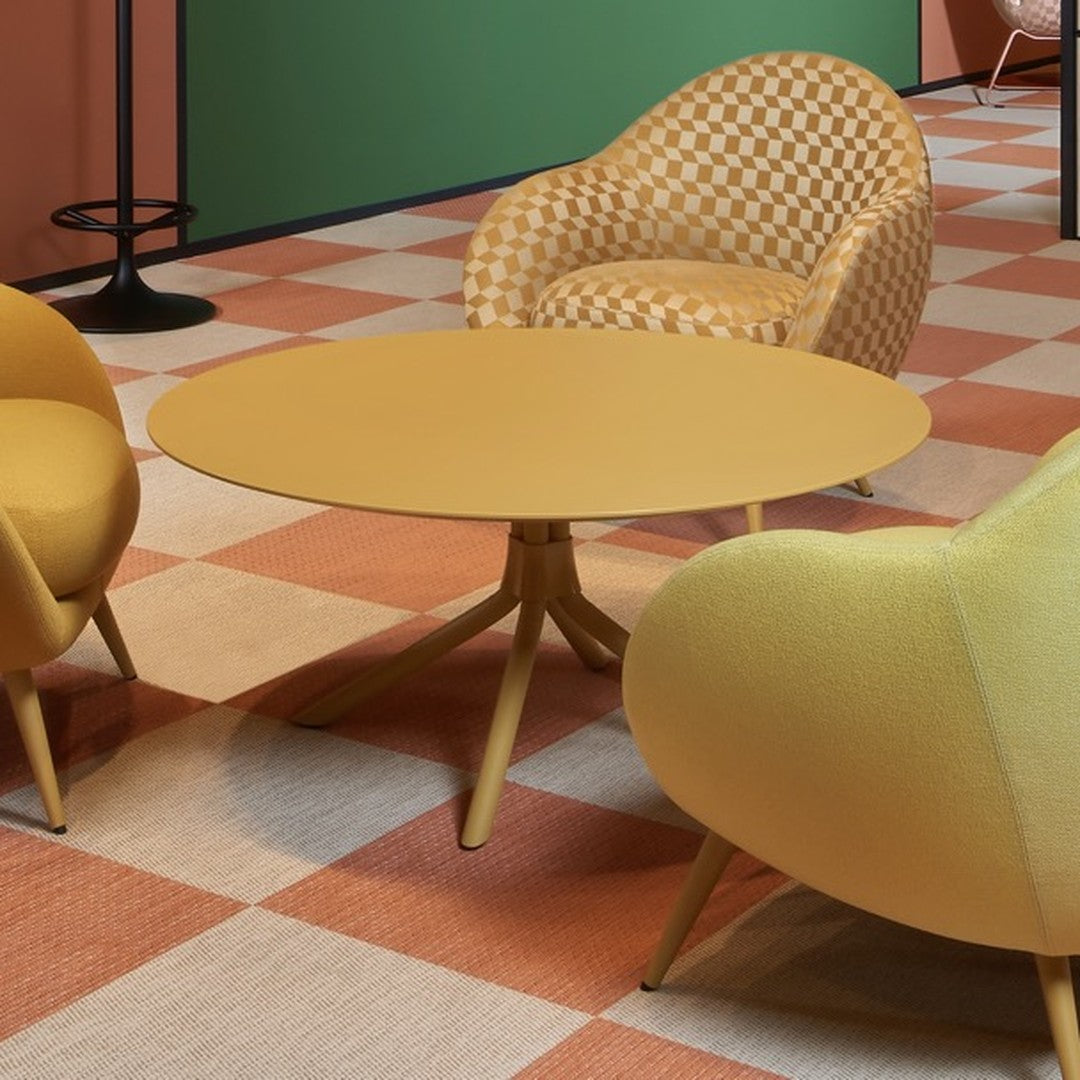 Yellow round table with textured surface, paired with orange and cream checkered chairs on a patterned floor.