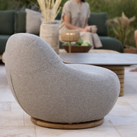 Stylish grey upholstered lounge chair with a rounded shape and natural wood base, perfect for modern outdoor settings.