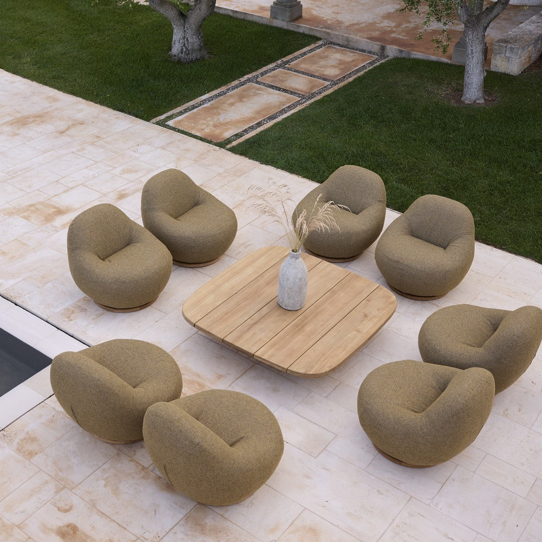 Earthy beige chairs with soft curves arranged around a light wooden table, set on a natural stone patio.