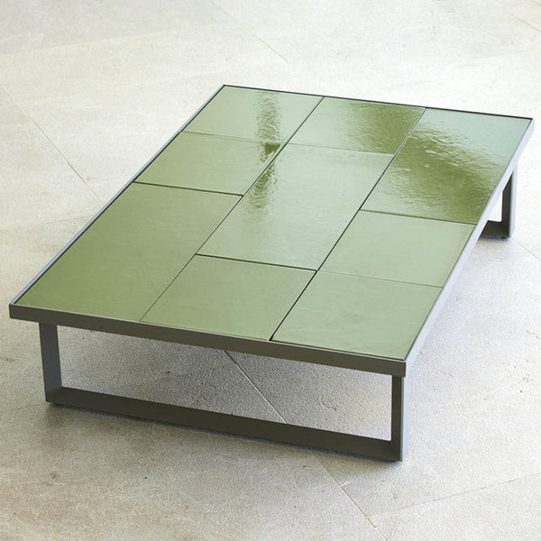 Green tiled coffee table with a glossy finish and a modern geometric design. Ideal for contemporary decor.