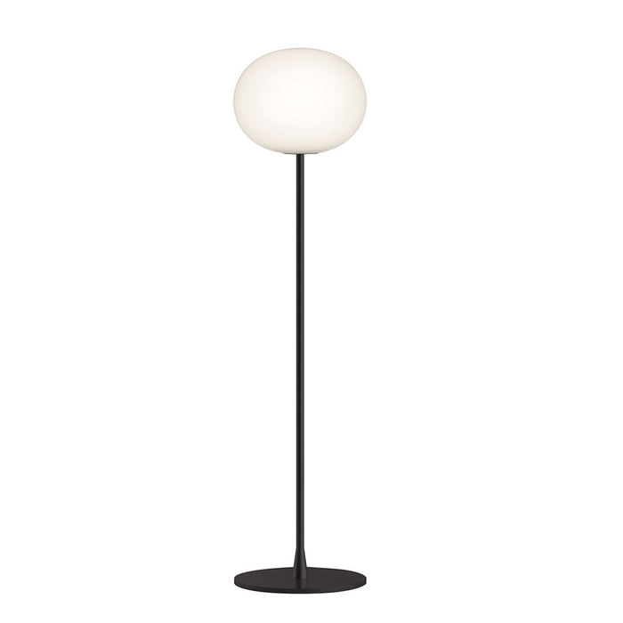 Sleek black floor lamp with a smooth white orb shade, perfect for modern decor.