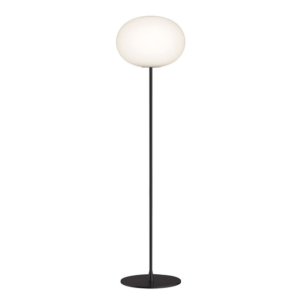 Modern floor lamp with a sleek black base and a rounded white glass shade, adding elegance to any space.