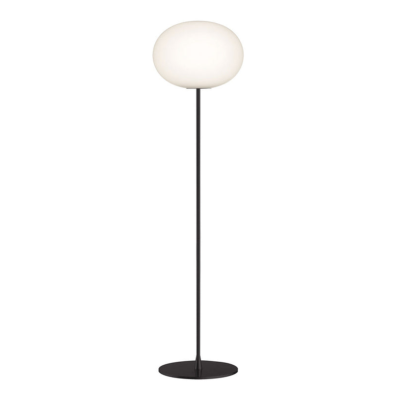 Modern floor lamp with a sleek black base and a rounded white glass shade, adding elegance to any space.
