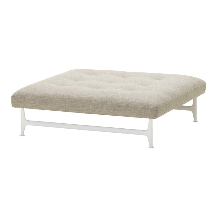 Beige tufted ottoman with a minimalist white metal frame, perfect for modern decor.