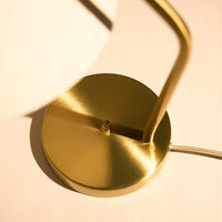 Gold lamp base with a sleek, brushed finish and minimalistic design, highlighting elegant curves and clean lines.