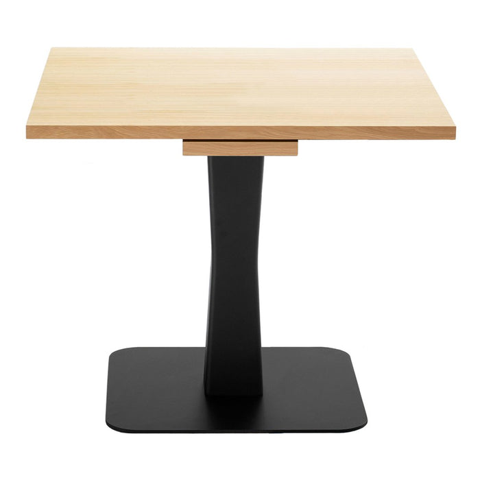 Light wood tabletop with natural grain on a sleek black metal base. Modern design with contrasting colors.