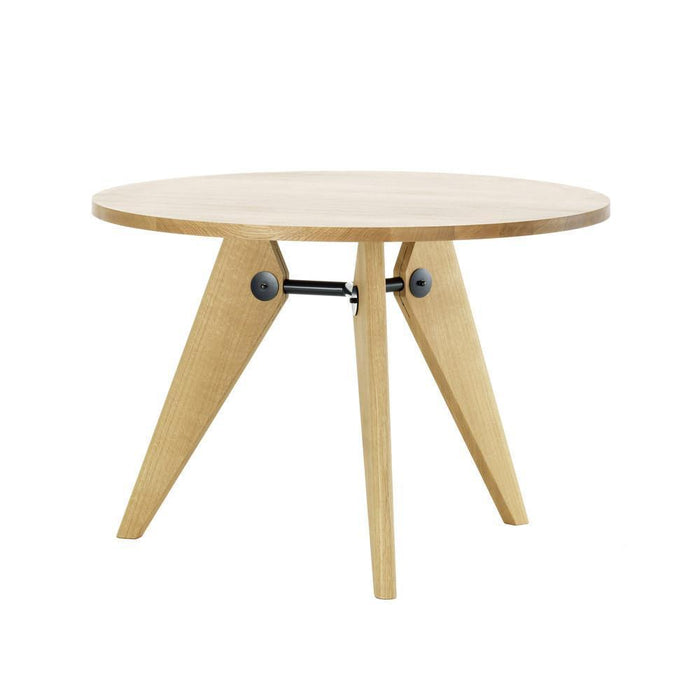 Round wooden table with a natural finish, featuring light blonde wood and minimalist geometric legs in a triangular design.