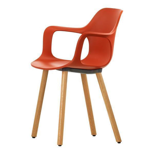 Bright orange chair with smooth curves and wooden legs, perfect for modern decor. Ideal for indoor and outdoor use.