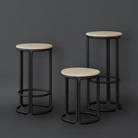 Three modern bar stools featuring round wood tops and sleek black metal frames, set against a dark backdrop.