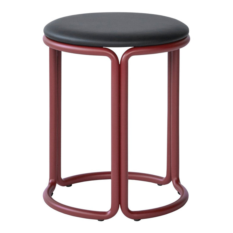 "Round black padded stool with a sleek red metal base, featuring a minimalist design and modern aesthetic."