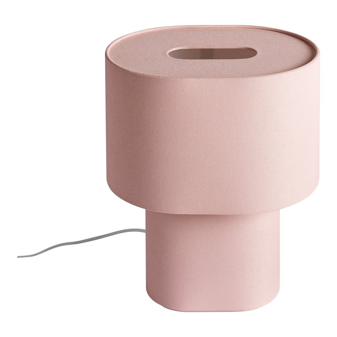 Pink cylindrical lamp with a textured finish and a cutout top, perfect for modern decor.