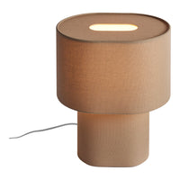 Modern beige table lamp with a smooth, round shade and cylindrical base, featuring a subtle cutout for light.