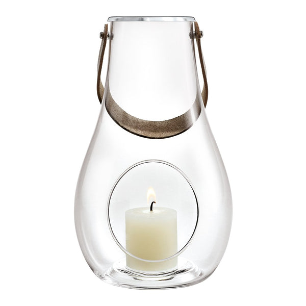 Clear glass lantern with a silver handle and a white candle inside, featuring a minimalist design and smooth contours.