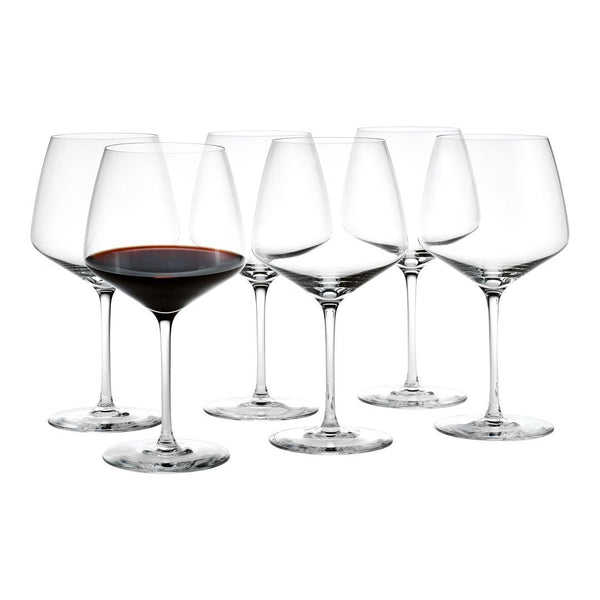 Set of six clear crystal wine glasses, featuring elegant stems and a classic design, showcasing rich red wine in one glass.