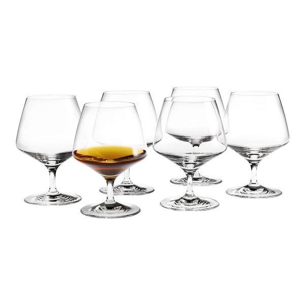 Clear glass whiskey tumblers with elegant curves, featuring a rich amber drink in one glass. Simple and modern design.